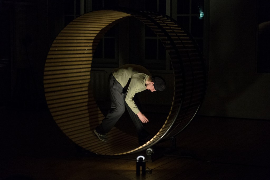 Artist Joey Schrauwen inside a giant wheel